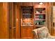 Custom wet bar with built-in shelving, a sink, and wood cabinetry, perfect for entertaining guests at 2167 W Wesley Nw Rd, Atlanta, GA 30327