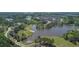 Scenic aerial view of a community with houses nestled amongst lush trees and a serene lake at 550 Breton Highlands, Fairburn, GA 30213