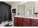 Bathroom with cherry wood cabinets, double sinks, and decorative accents at 550 Breton Highlands, Fairburn, GA 30213
