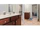 Dual vanities, tile floors, and bright lighting provide a functional and appealing bathroom space at 550 Breton Highlands, Fairburn, GA 30213