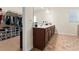 Bathroom with double vanity, walk-in closet and tile floor offers both style and ample storage at 550 Breton Highlands, Fairburn, GA 30213