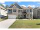 Charming two-story home with manicured lawn, brick facade, and a two-car garage at 550 Breton Highlands, Fairburn, GA 30213