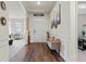 Inviting foyer featuring hardwood floors, elegant decor, and a view into the living room at 550 Breton Highlands, Fairburn, GA 30213