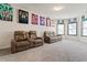 Entertainment room with plush seating, sports memorabilia, and natural light creates a fun space at 550 Breton Highlands, Fairburn, GA 30213