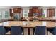 Large island kitchen featuring granite countertops, stainless appliances, and seating at 550 Breton Highlands, Fairburn, GA 30213