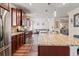 Open kitchen with stainless steel appliances, island with granite countertop, and view of living area at 550 Breton Highlands, Fairburn, GA 30213
