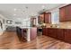 Spacious kitchen with cherry wood cabinets, stainless steel appliances, and a large island at 550 Breton Highlands, Fairburn, GA 30213