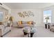 Bright living room with neutral tones, plush seating, and a clear view of the front yard at 550 Breton Highlands, Fairburn, GA 30213