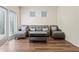 Cozy seating area with wicker furniture, natural light from french doors, and hardwood floors creates an inviting space at 550 Breton Highlands, Fairburn, GA 30213