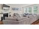 Living room with a fireplace, a large sectional couch, and windows at 550 Breton Highlands, Fairburn, GA 30213