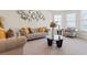 Comfortable living room with modern decor, plush seating, and a glass coffee table at 550 Breton Highlands, Fairburn, GA 30213