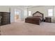 Spacious main bedroom features elegant dark wood furniture and french doors to the ensuite at 550 Breton Highlands, Fairburn, GA 30213