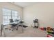 Bright home office features a glass desk and ample natural light, perfect for productivity at 550 Breton Highlands, Fairburn, GA 30213