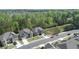 Aerial view of houses on a street with mature landscaping and plenty of green spaces at 550 Breton Highlands, Fairburn, GA 30213