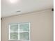 A window with white trim and blinds stands out against a neutral wall, offering natural light at 550 Breton Highlands, Fairburn, GA 30213