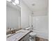 Bright bathroom with granite countertop, white cabinets, and a tub/shower combination at 10924 Hondal Ct, Hampton, GA 30228
