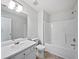 Bright bathroom features a vanity with sink, toilet, and shower-tub combination, perfect for a fresh, clean design at 10924 Hondal Ct, Hampton, GA 30228