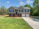 Inviting two-story home boasts a well-maintained lawn and a two car garage at 10924 Hondal Ct, Hampton, GA 30228