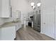 The kitchen features white cabinets, stainless steel appliances, and a granite countertop at 10924 Hondal Ct, Hampton, GA 30228