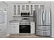 Modern kitchen with stainless steel appliances, granite countertops, and ample storage at 10924 Hondal Ct, Hampton, GA 30228