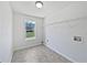 Bright laundry room features a window and a wire rack, perfect for keeping your home organized at 10924 Hondal Ct, Hampton, GA 30228