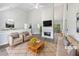Bright living room with high ceilings, fireplace, and stylish neutral furnishings at 10924 Hondal Ct, Hampton, GA 30228