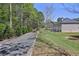 Large backyard featuring a bocce ball court, grassy area, and a peaceful wooded backdrop at 1622 Bunting Forest Ct, Marietta, GA 30064
