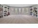 Large bonus room with built in shelving and neutral colored carpet at 1622 Bunting Forest Ct, Marietta, GA 30064