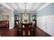 Elegant dining room with wainscoting, hardwood floors, and a stylish light fixture at 1622 Bunting Forest Ct, Marietta, GA 30064
