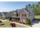 Charming two-story home boasts manicured landscaping and a long driveway with side-entry garages at 1622 Bunting Forest Ct, Marietta, GA 30064