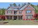Impressive two-story brick home with stone accents, manicured lawn, and charming curb appeal at 1622 Bunting Forest Ct, Marietta, GA 30064