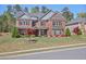 Stunning brick two-story home with mature landscaping, black shutters, and a well-manicured front lawn at 1622 Bunting Forest Ct, Marietta, GA 30064
