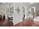Hallway with hardwood flooring, detailed trim work, and decorative wall accents leading to various rooms at 1622 Bunting Forest Ct, Marietta, GA 30064