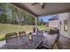 Covered patio with an outdoor dining set, grill, and seating, perfect for relaxation at 1622 Bunting Forest Ct, Marietta, GA 30064