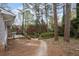 Lush backyard featuring mature trees, manicured shrubs, and a stone pathway leading to a tranquil setting at 2000 Hill Rd, Marietta, GA 30062
