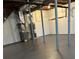 Unfinished basement with painted floor, support beams, and utility systems ready for customization and storage at 2000 Hill Rd, Marietta, GA 30062
