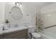 Cozy bathroom with white-tiled shower/tub, modern vanity and fixtures, and handicap safety bars at 2000 Hill Rd, Marietta, GA 30062