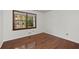 Empty bedroom with wood floors and natural light from a large window overlooking yard at 2000 Hill Rd, Marietta, GA 30062