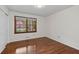 Inviting bedroom features hardwood floors, ample natural light, and a glimpse of blossoming trees outside at 2000 Hill Rd, Marietta, GA 30062