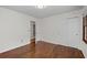 Bright bedroom featuring hardwood floors, closet, neutral walls, and access to a connecting room at 2000 Hill Rd, Marietta, GA 30062