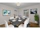 Dining room featuring a modern table and chairs, complemented by stylish artwork and natural light at 2000 Hill Rd, Marietta, GA 30062