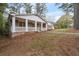 Beautiful brick home showcasing a spacious front porch and a meticulously landscaped front yard, perfect for relaxation at 2000 Hill Rd, Marietta, GA 30062