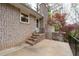 Charming brick home exterior with patio, featuring mature trees and outdoor living space at 2000 Hill Rd, Marietta, GA 30062