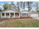 Inviting brick home featuring a delightful front porch, columns and manicured landscaping enhancing its curb appeal at 2000 Hill Rd, Marietta, GA 30062