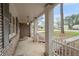 Relaxing covered front porch with brick accents, white pillars, and serene outdoor views, perfect for enjoying the fresh air at 2000 Hill Rd, Marietta, GA 30062