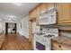 Spacious kitchen with wood cabinets, granite countertops, and modern appliances at 2000 Hill Rd, Marietta, GA 30062