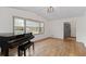 Inviting living room featuring hardwood floors, a piano, and a large window, creating a warm and inviting space at 2000 Hill Rd, Marietta, GA 30062