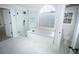 Modern bathroom with a glass-enclosed shower and soaking tub at 2328 New Haven Pl, Conyers, GA 30094