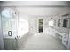 Luxurious bathroom with a soaking tub and large window at 2328 New Haven Pl, Conyers, GA 30094