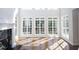 Sun-drenched living room featuring hardwood floors, fireplace, and large windows at 2328 New Haven Pl, Conyers, GA 30094
